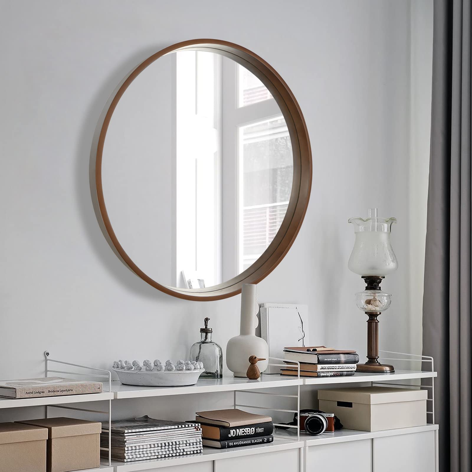 WallBeyond living room round mirror reflects light to enlarge small spaces.