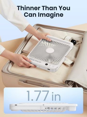 Warmco portable desk fan shown in a cozy bedroom setting.
