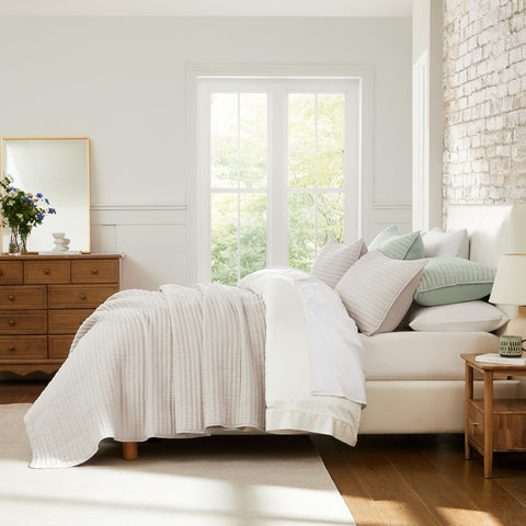 WDCOZY beige pick-stitch king-size bed with quilt in a cozy bedroom setup.