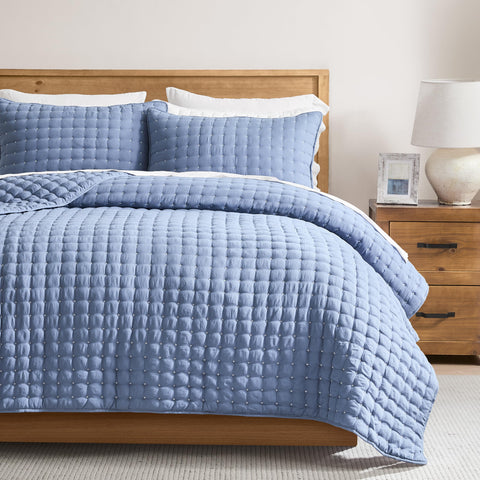 WDCOZY blue queen quilt draped on bed for all-season comfort.