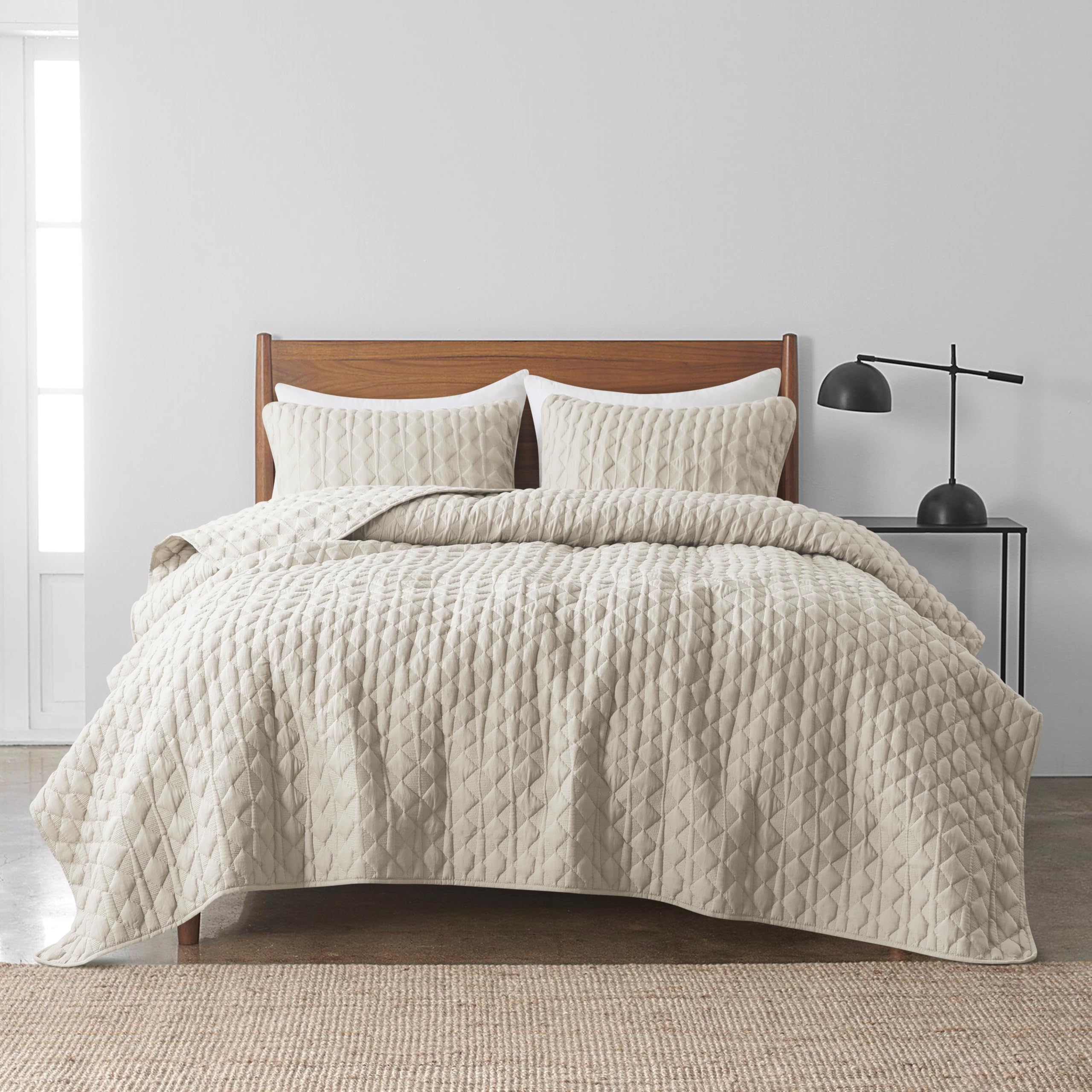 WDCOZY quilt draped on a Cal King bed showing all-season coverage.