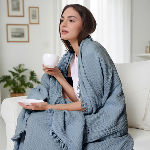 WDCOZY Muslin Blanket on sofa demonstrates twin-size 60x80 fit for bedrooms.