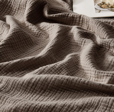 WDCOZY muslin throw blanket folded on sofa for warmth and style