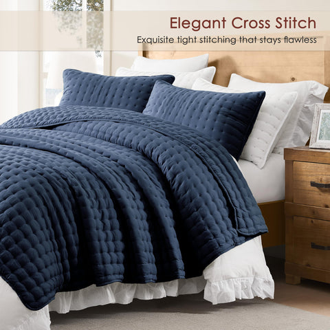 WDCOZY navy quilt with two pillow shams arranged on a bed