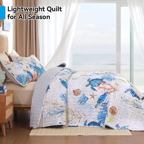 Weigelia coral detail on the quilt enhances coastal decor.
