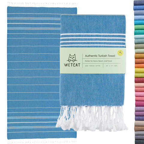 WETCAT Turkish beach towel oversized blue spread on sand, ideal for absorbency and coverage.
