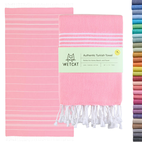 WetCat oversized Turkish towel in light pink on the beach for sand-free lounging.