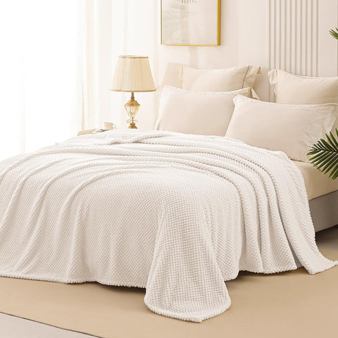 Whale Flotilla ivory blanket draped over sofa for cozy decor and warmth