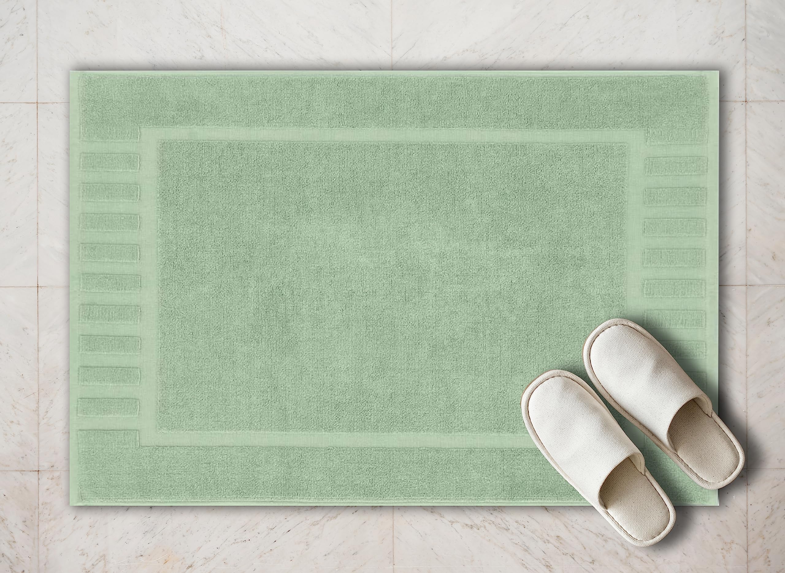 White Classic bath mat by sink in green for convenient floor comfort.