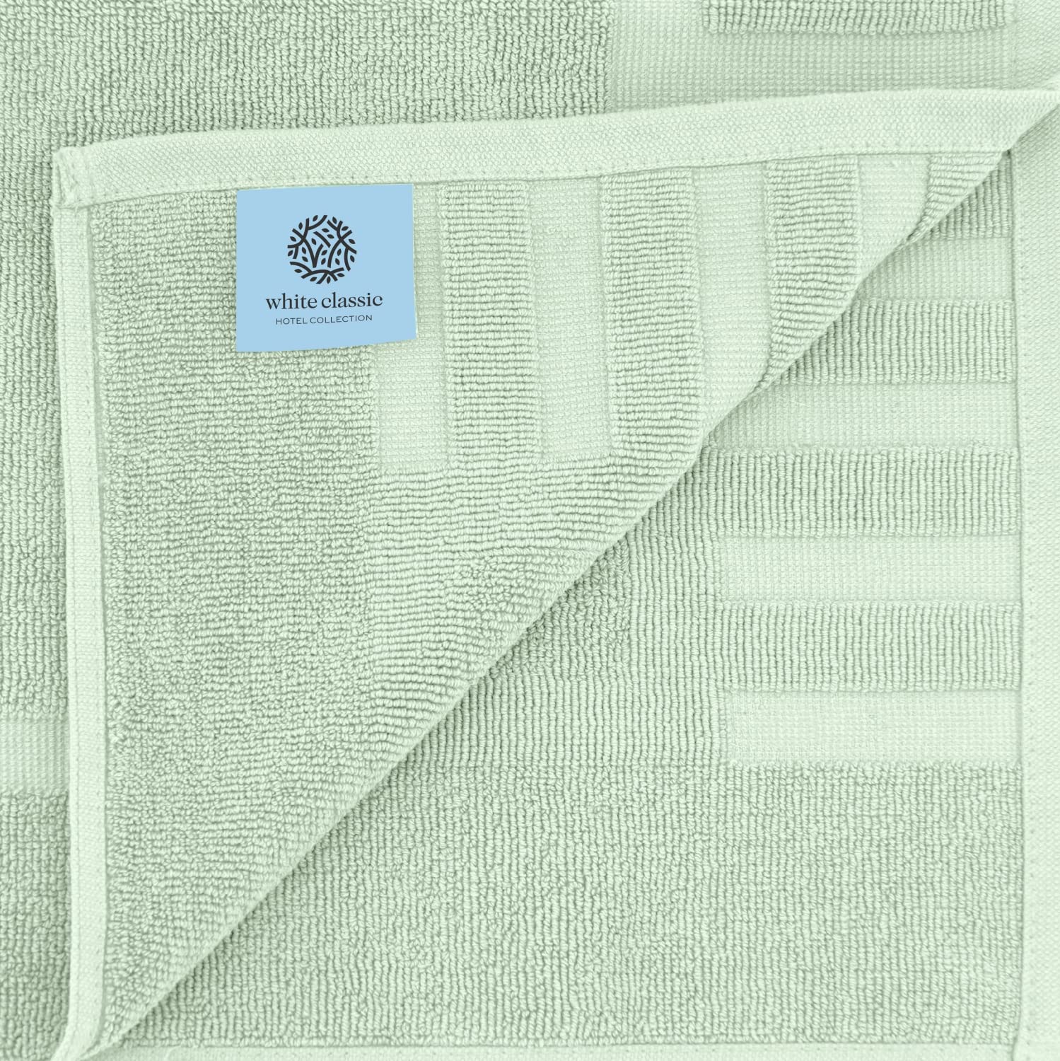 White Classic fast-dry bath mat in green after showers.