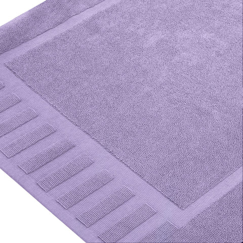 White Classic luxury bath mat laid flat on bathroom floor.