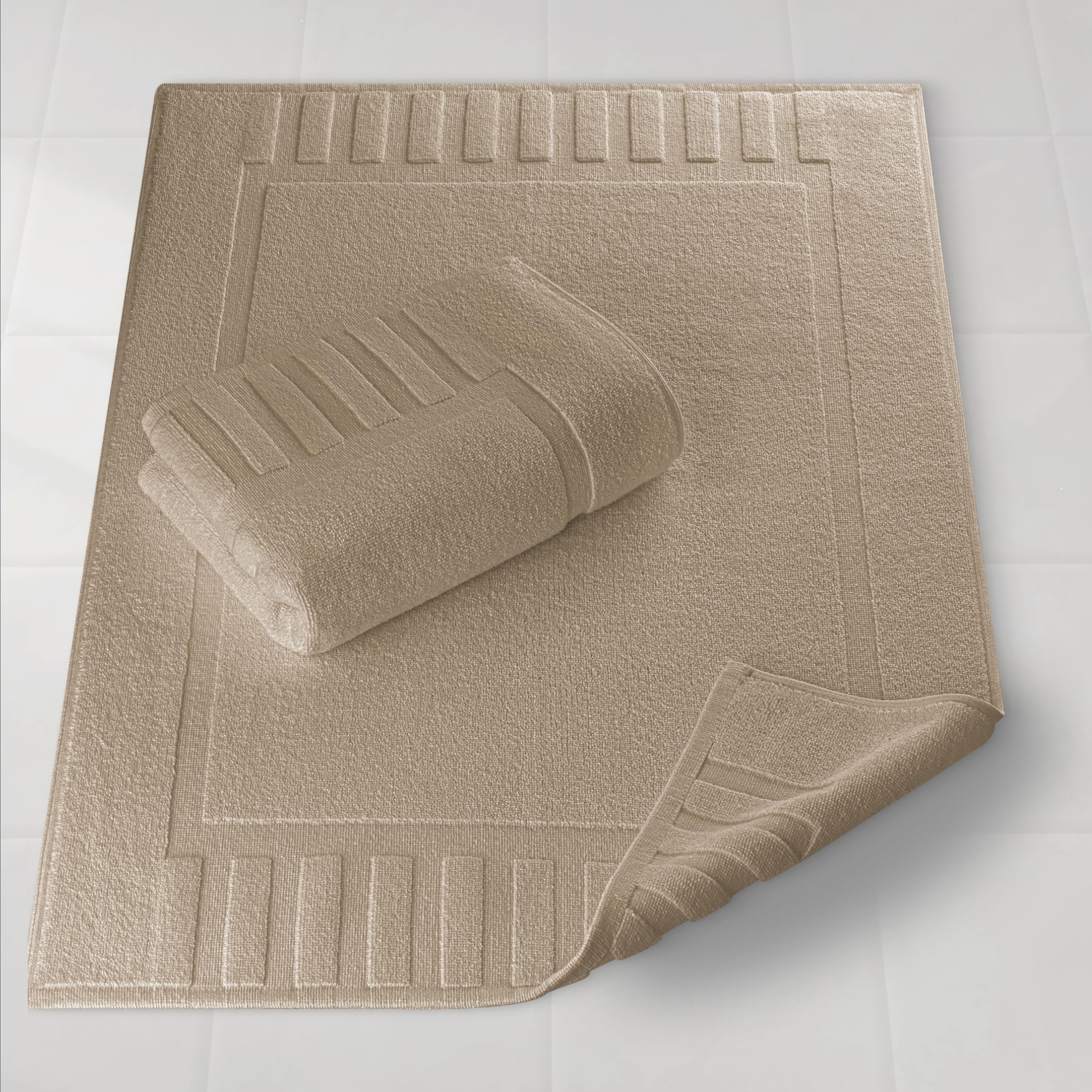 White Classic luxury bath mat taupe spread on floor for spa-like comfort.