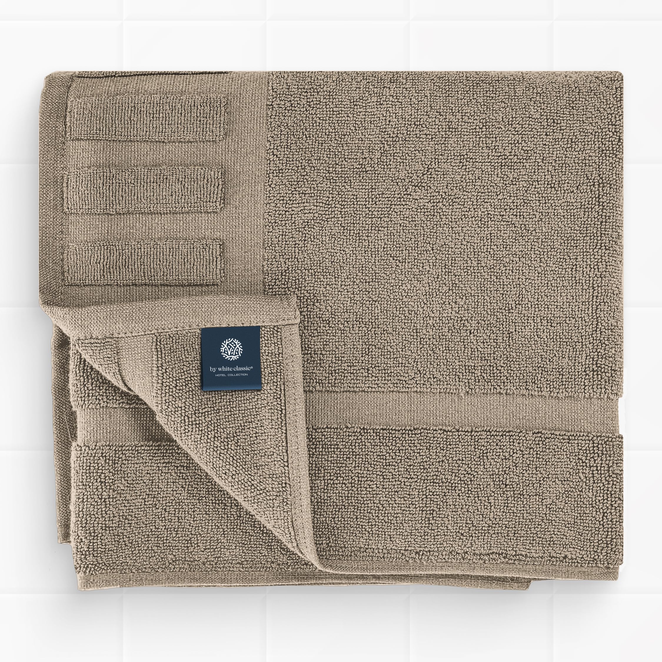 White Classic taupe bath mat in bathroom scene for soft stepping after shower.
