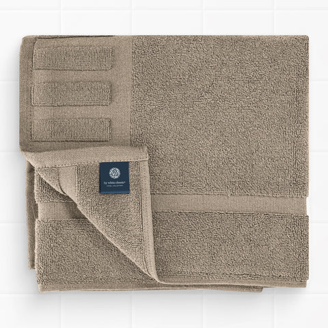 White Classic taupe bath mat in bathroom scene for soft stepping after shower.