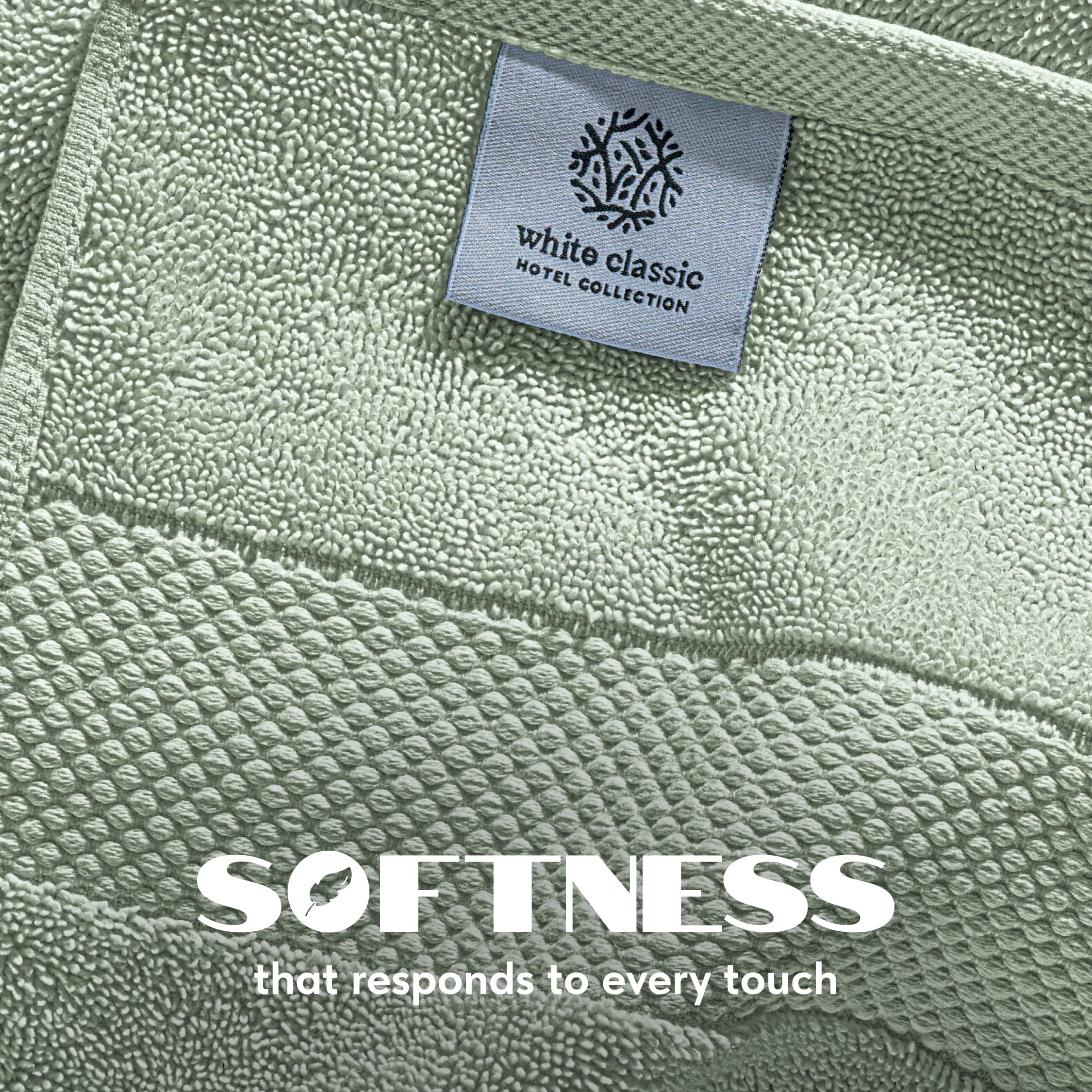 White Classic sage green towels folded neatly, add spa-like color to bathroom.