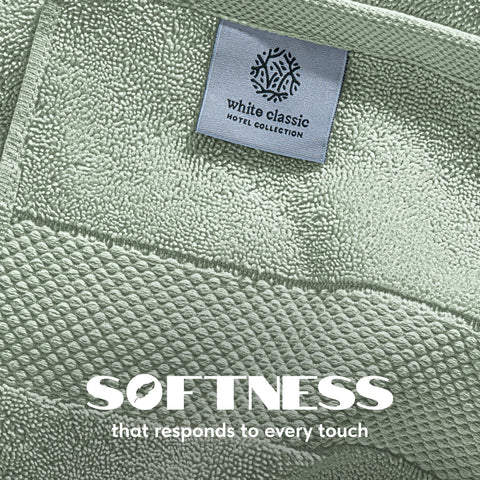 White Classic sage green towels folded neatly, add spa-like color to bathroom.