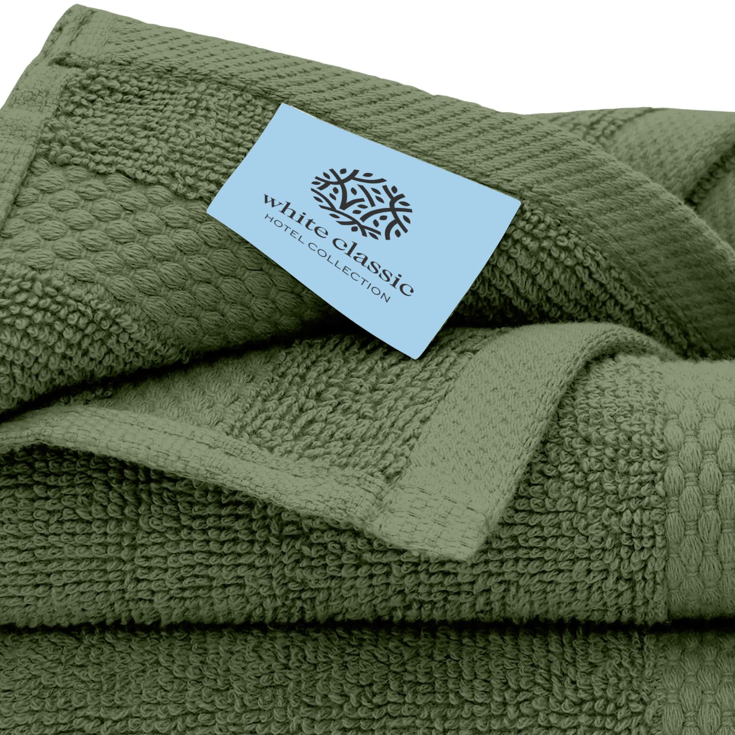 White Classic forest green washcloth on shelf in a bathroom setting