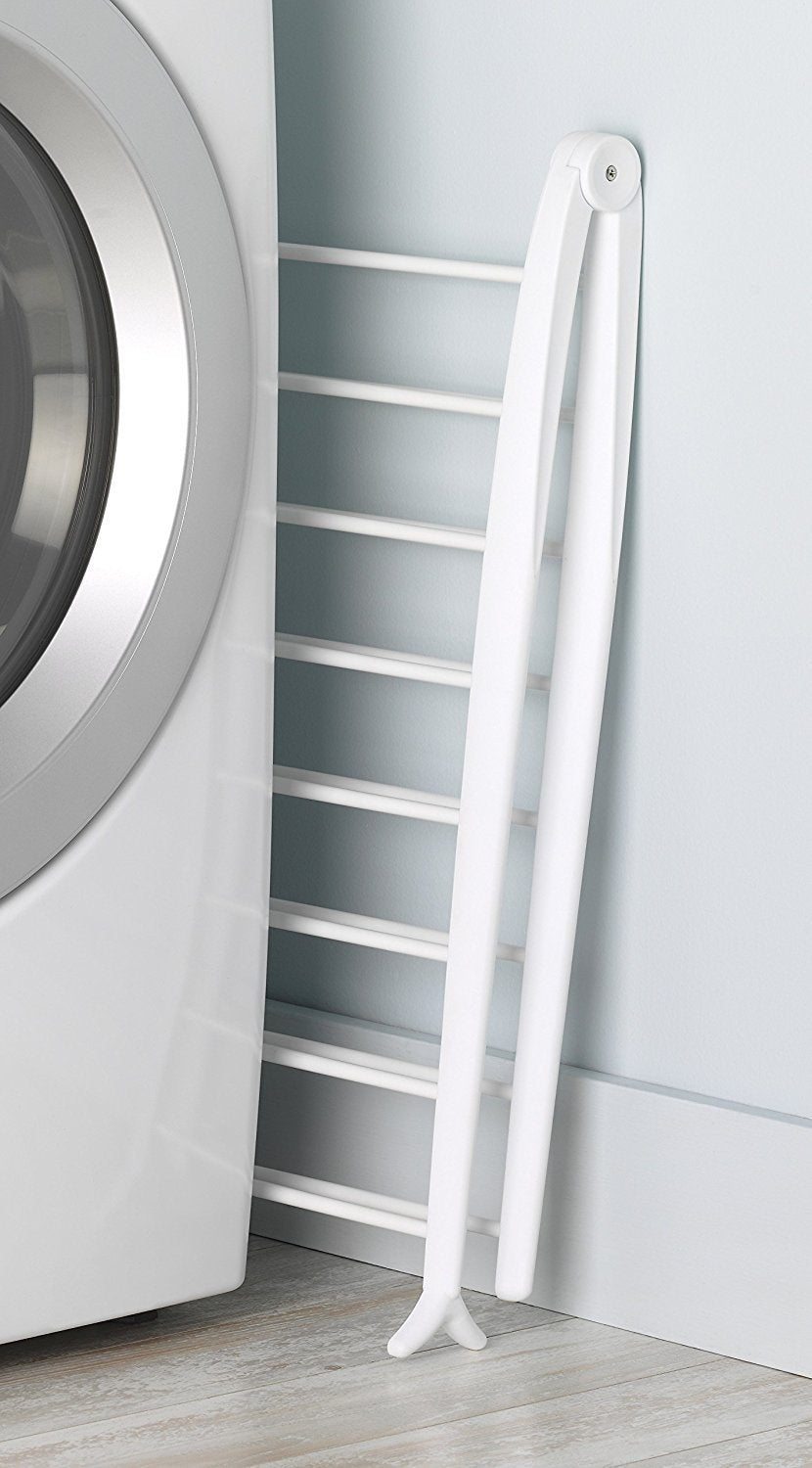 Whitmor Spacemaker drying rack stored flat beside a washing machine.