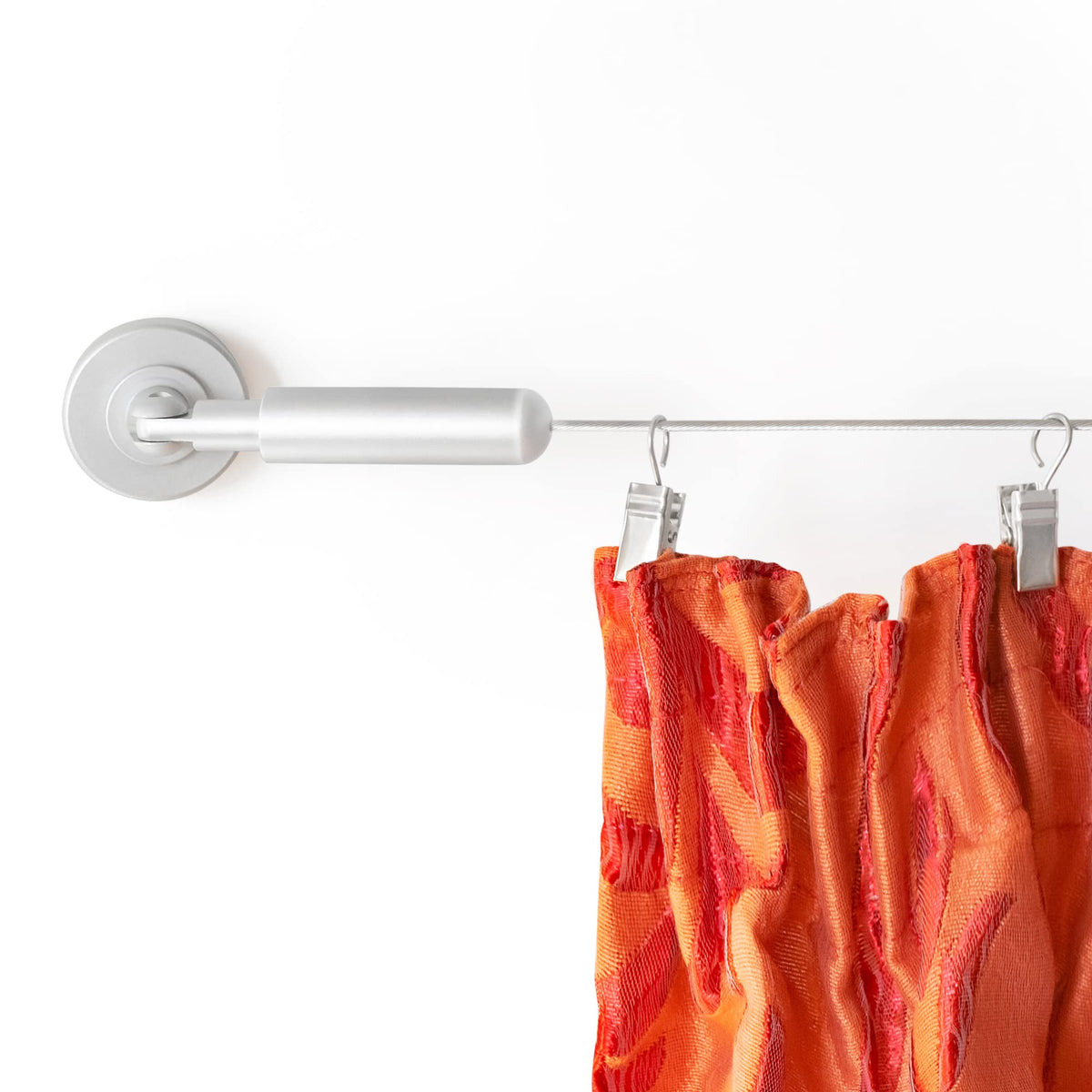 Willow and Eva wire curtain rod spans a window for a sleek divider