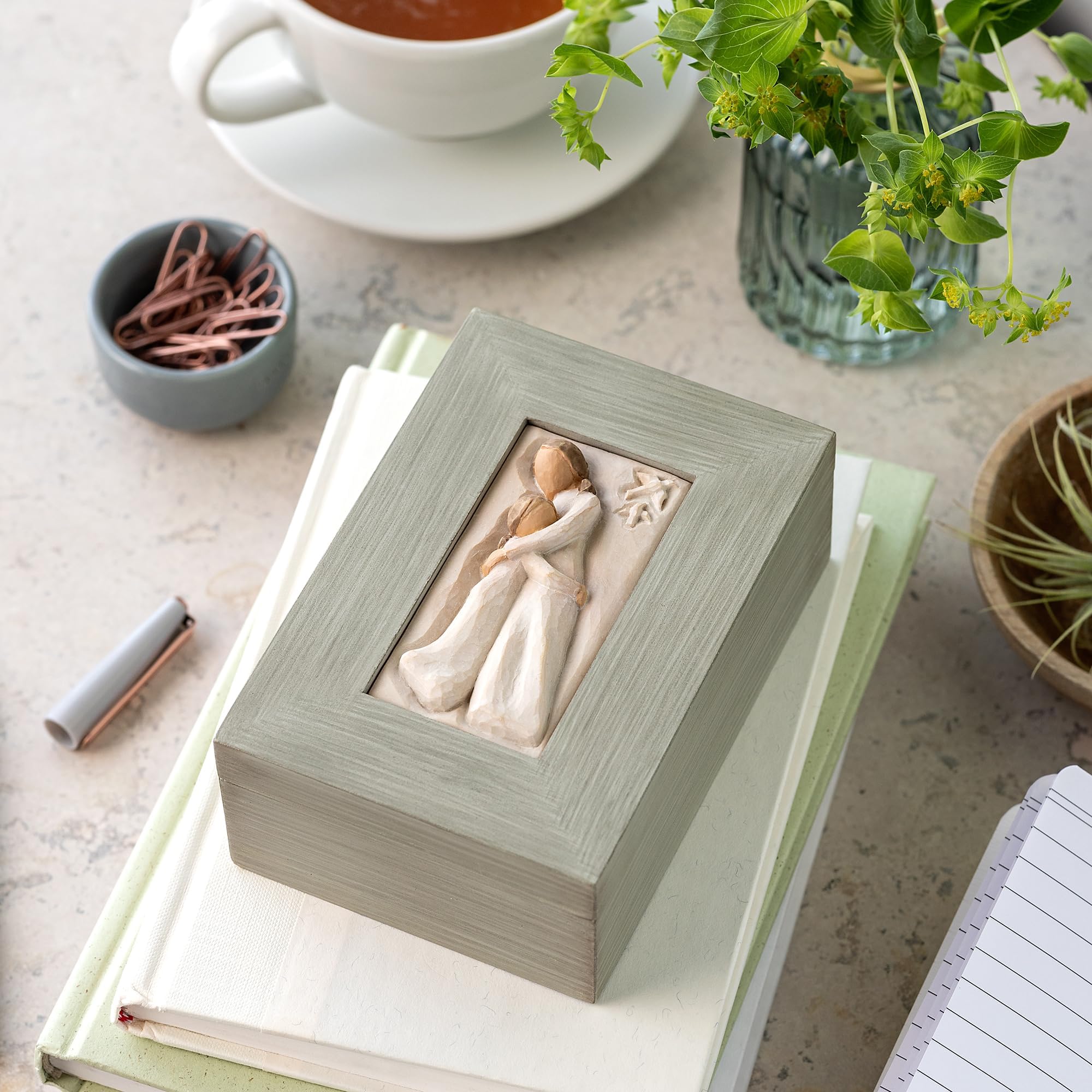 Willow Tree memory box displayed on a shelf adds warm decor.