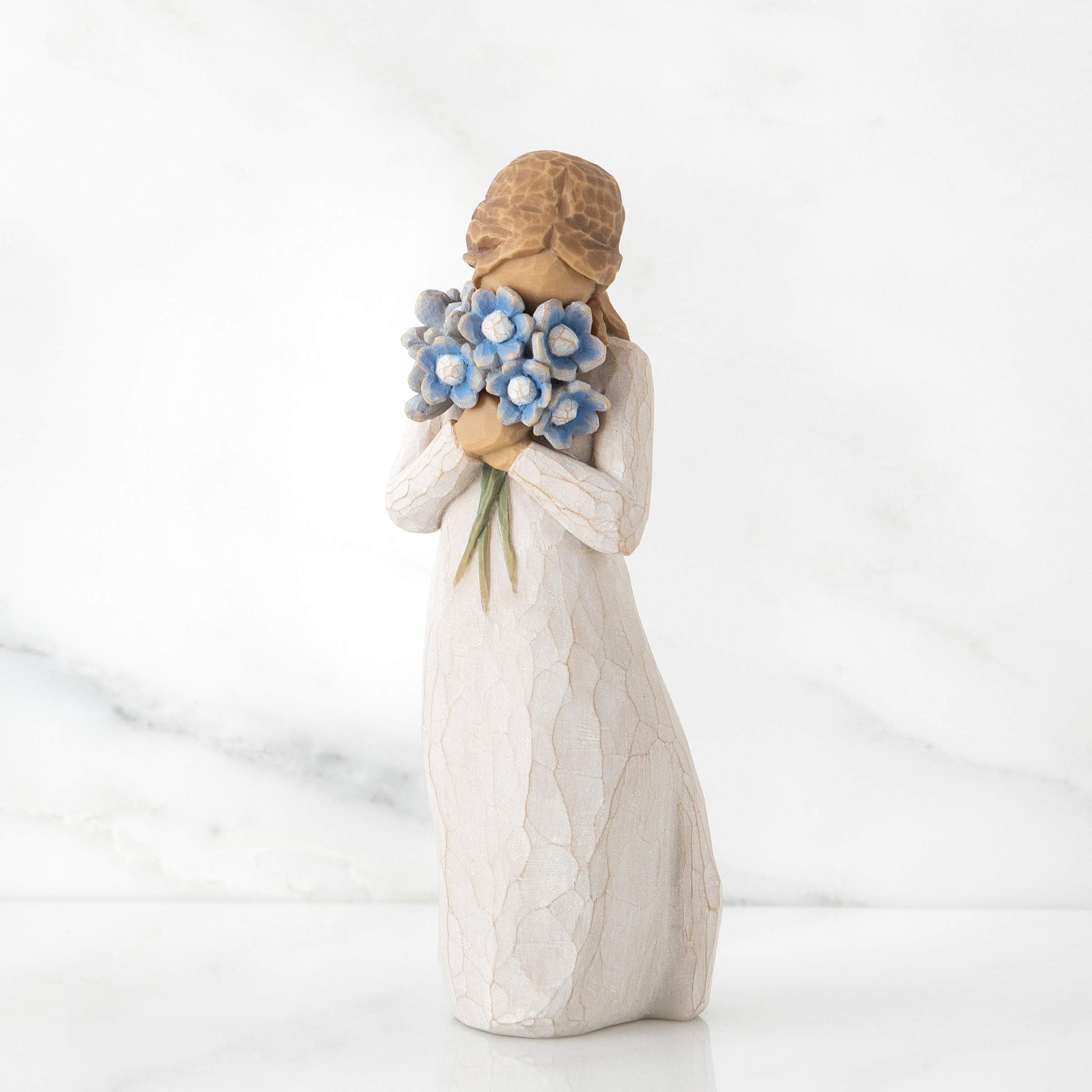 Willow Tree Forget-me-not figure side view highlighting cream dress and floral bouquet.