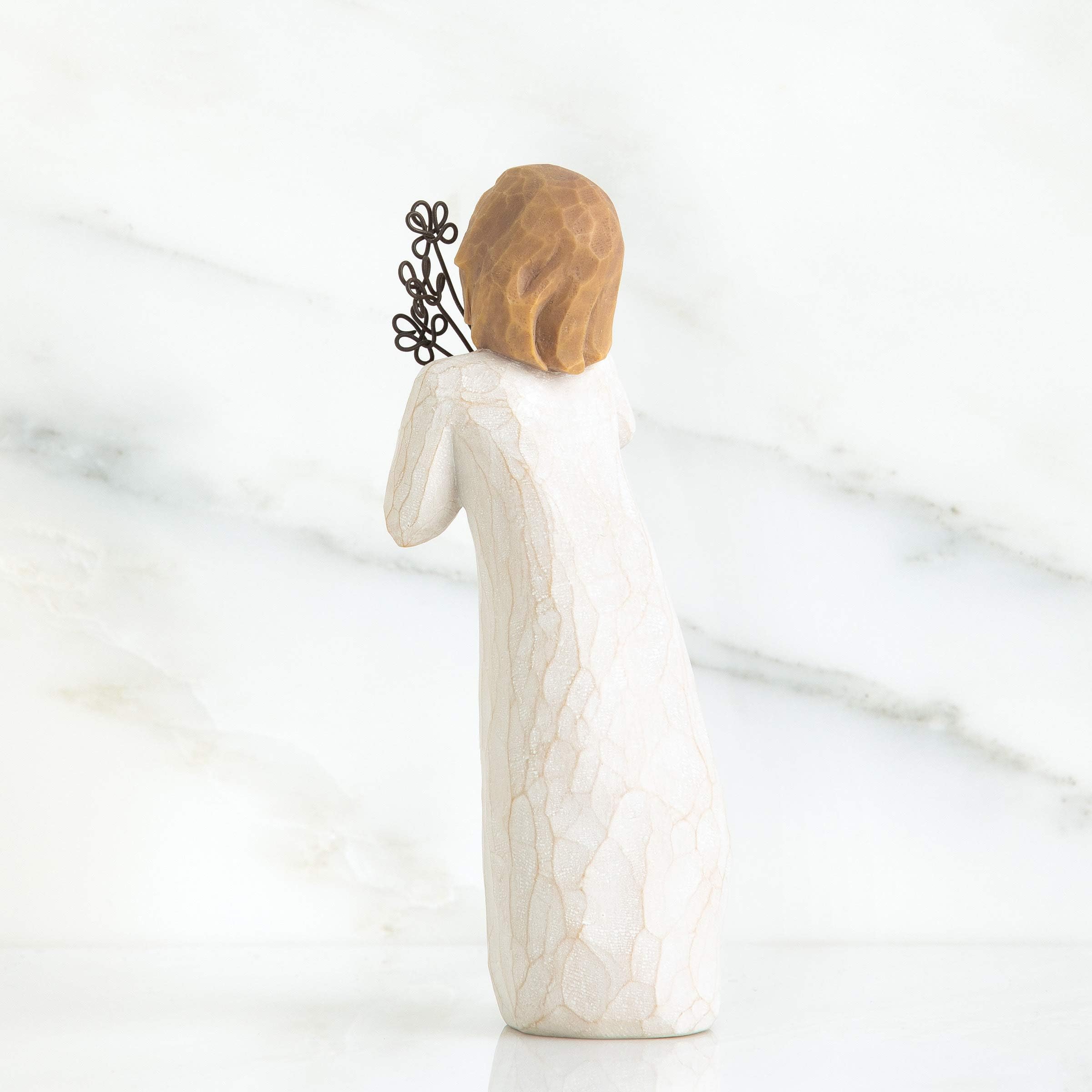 Hand-painted resin figure close-up of face and florals.
