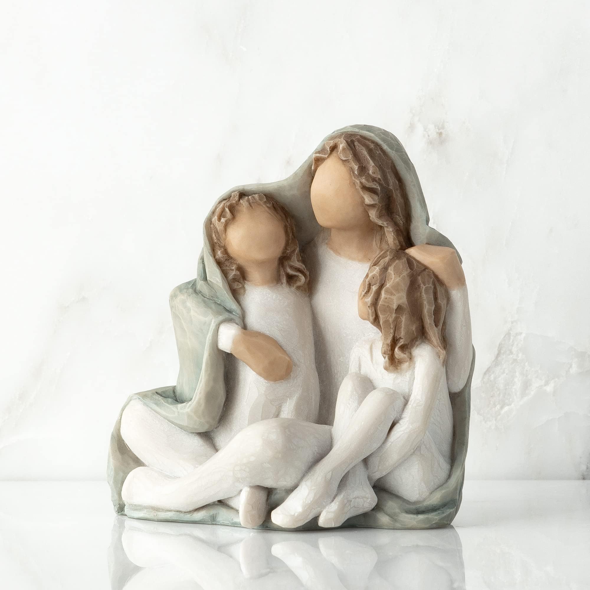 Willow Tree hand-painted resin figure detail showing cream clothing and two children for home display.