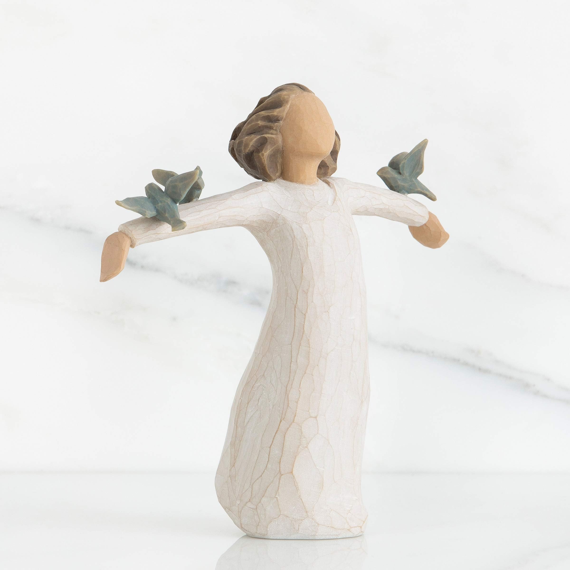 Willow Tree Happiness figure in cream dress showing hand-painted details.