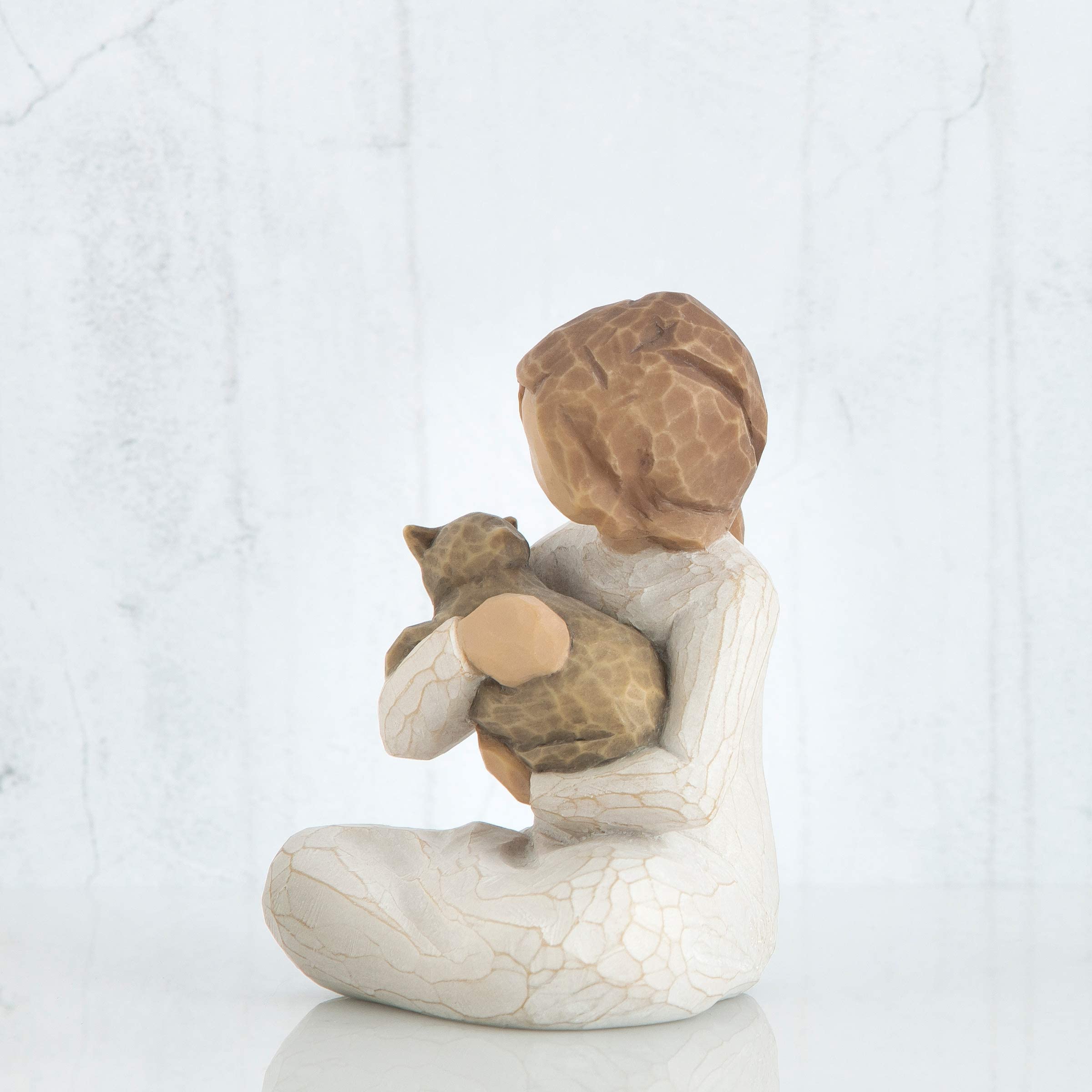 Willow Tree Kindness figure displayed on shelf or mantel.