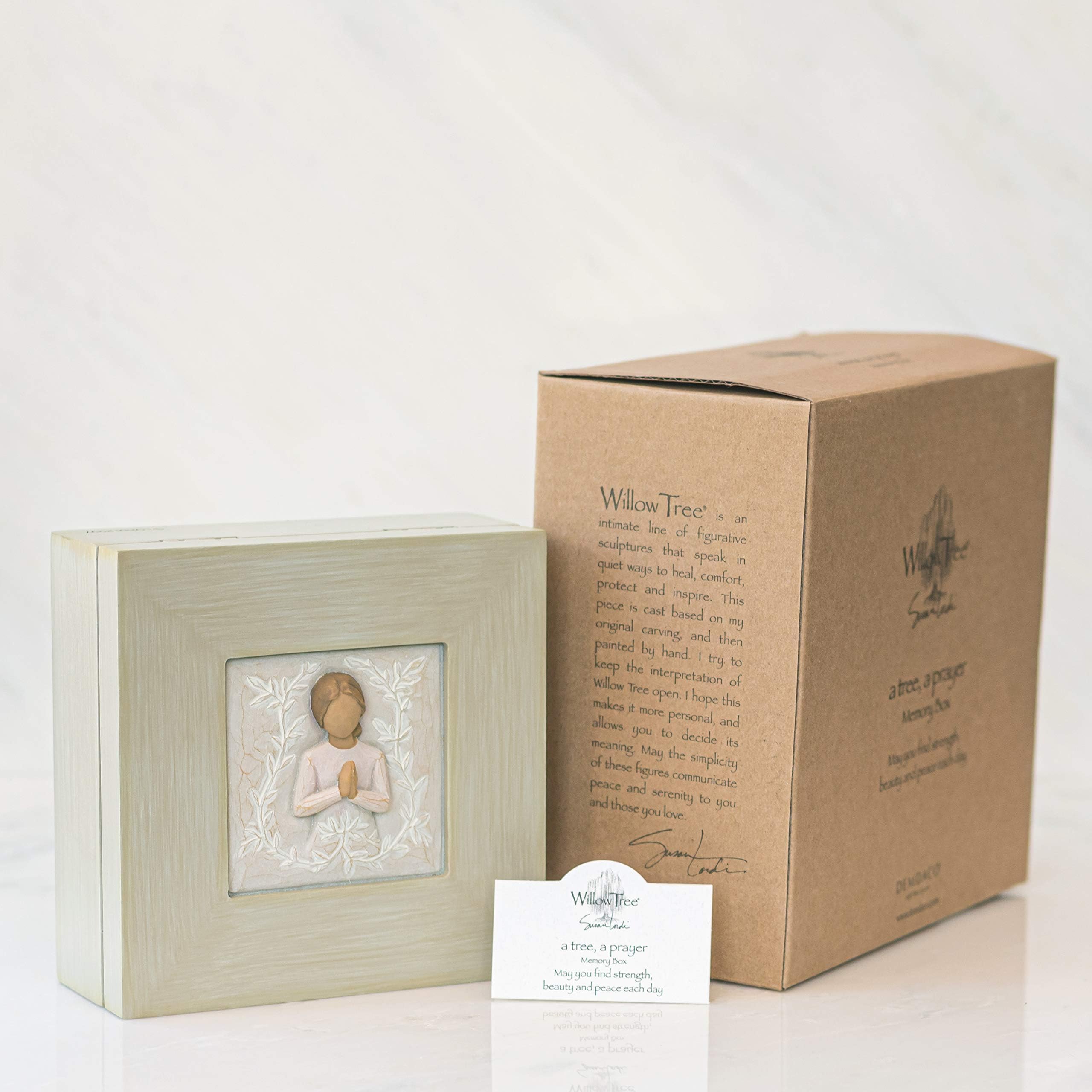 Willow Tree memory box displayed on a shelf or mantel for decoration.