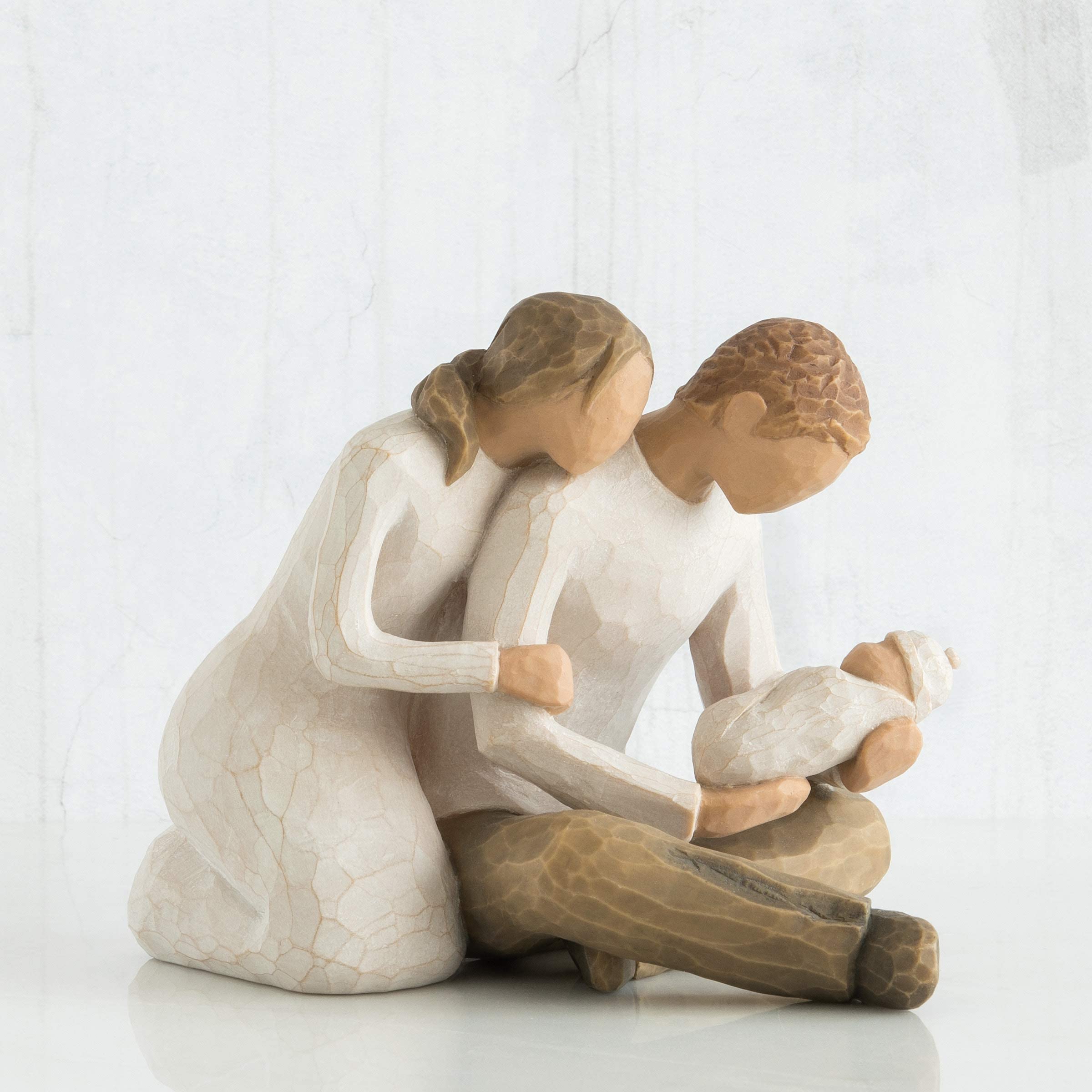 Willow Tree New Life couple with baby, hand-painted details showcase tenderness.