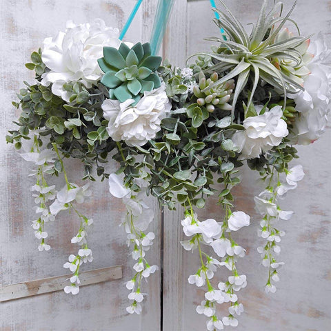 Winlyn doorway garland frames a welcome sign for guests.