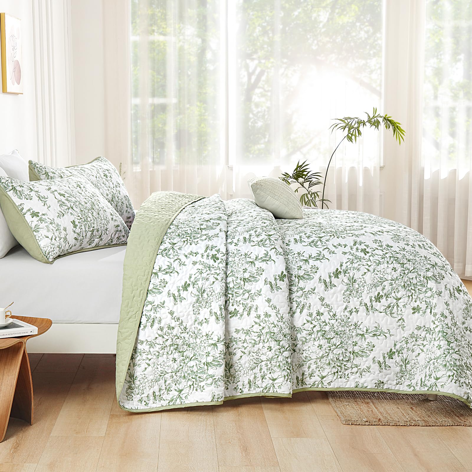 WONGS BEDDING botanical pattern quilt close-up highlights green and white floral design.