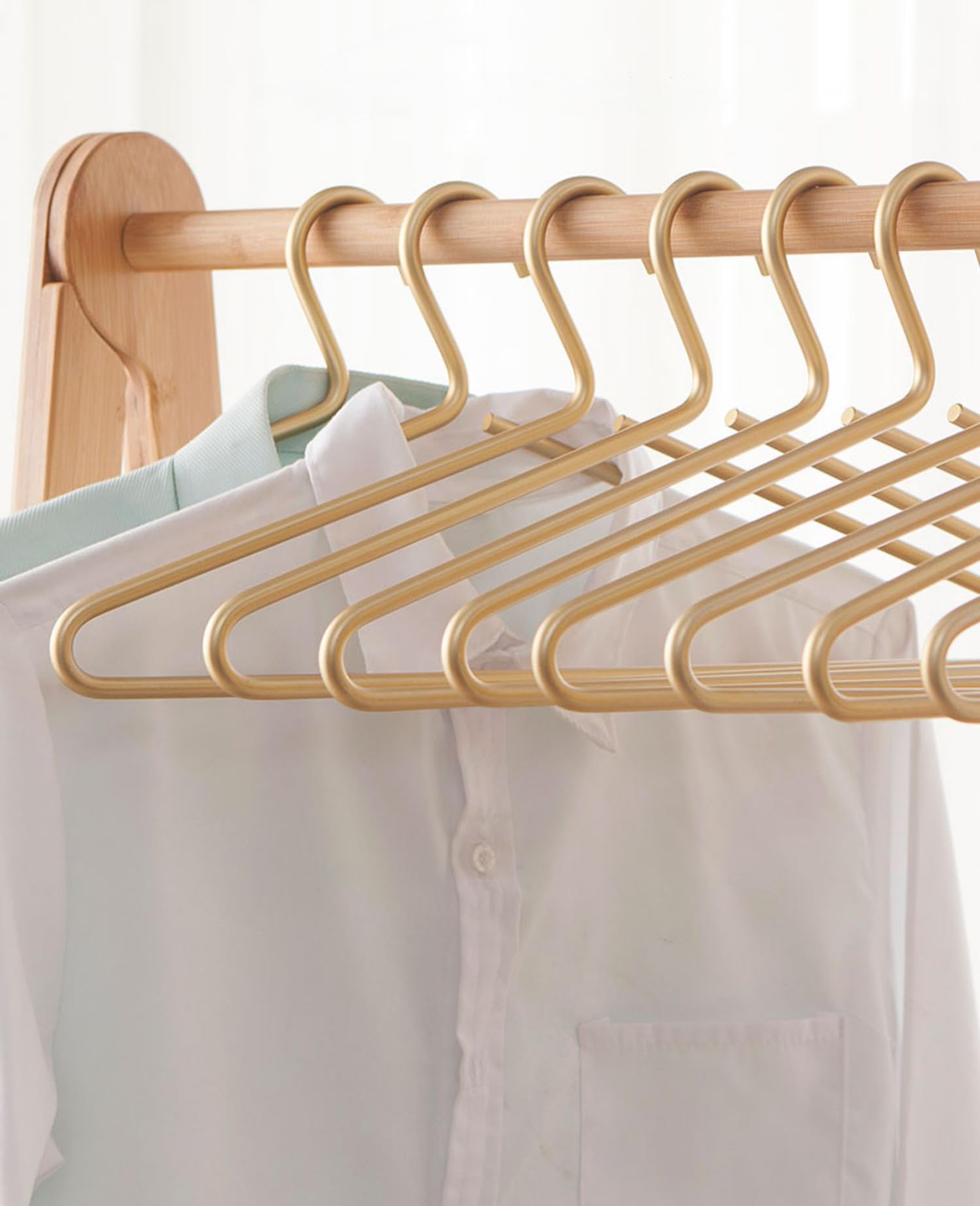 WONQEXZ premium matte gold hanger on a rod keeps wardrobe tidy and accessible.