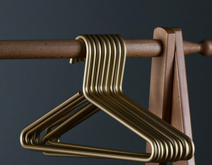 WONQEXZ ultra-slim matte gold aluminum hanger stacked for efficient closet storage.