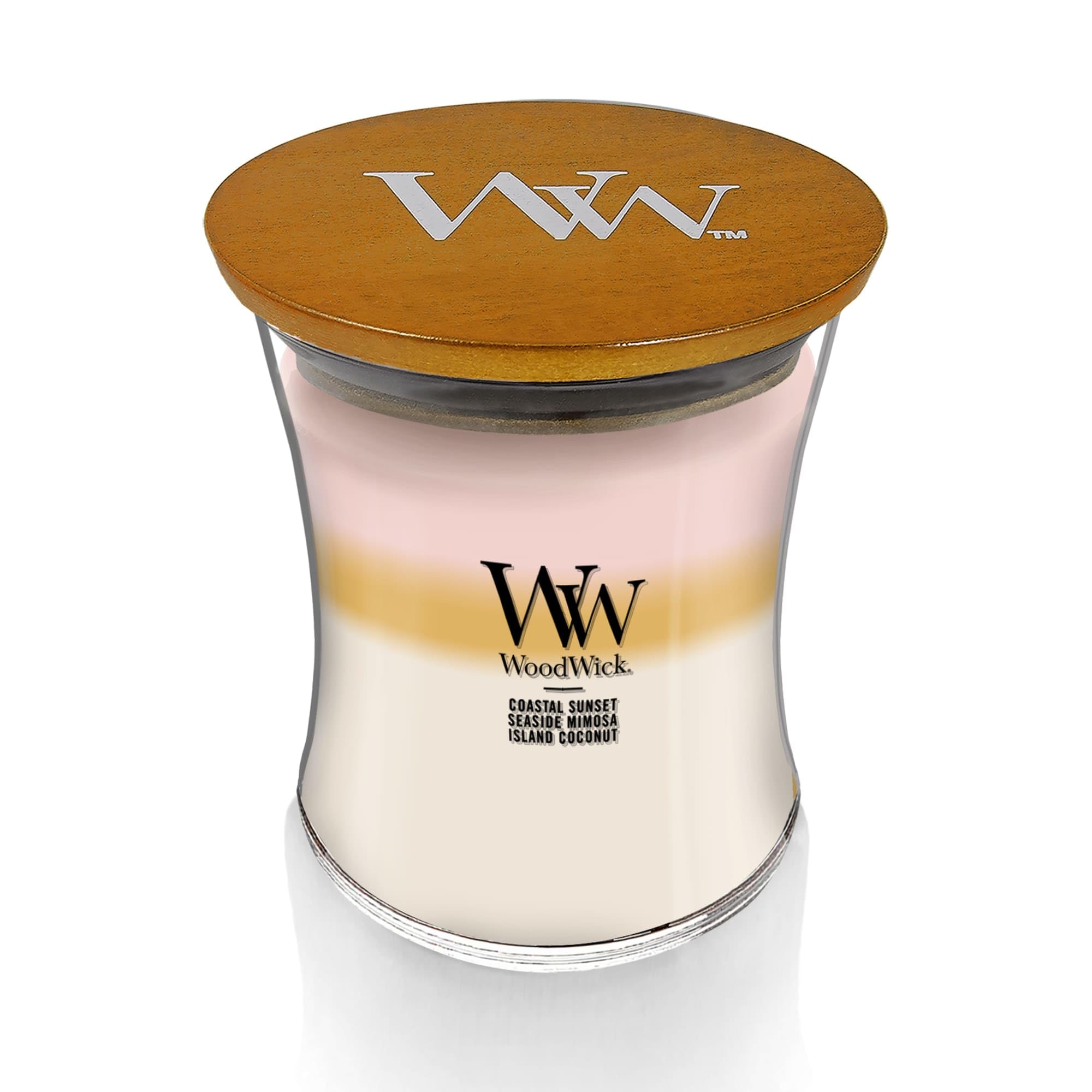 WoodWick Island Getaway Trilogy candle glow enhances mood with warm, inviting atmosphere.