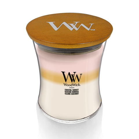 WoodWick Island Getaway Trilogy candle glow enhances mood with warm, inviting atmosphere.