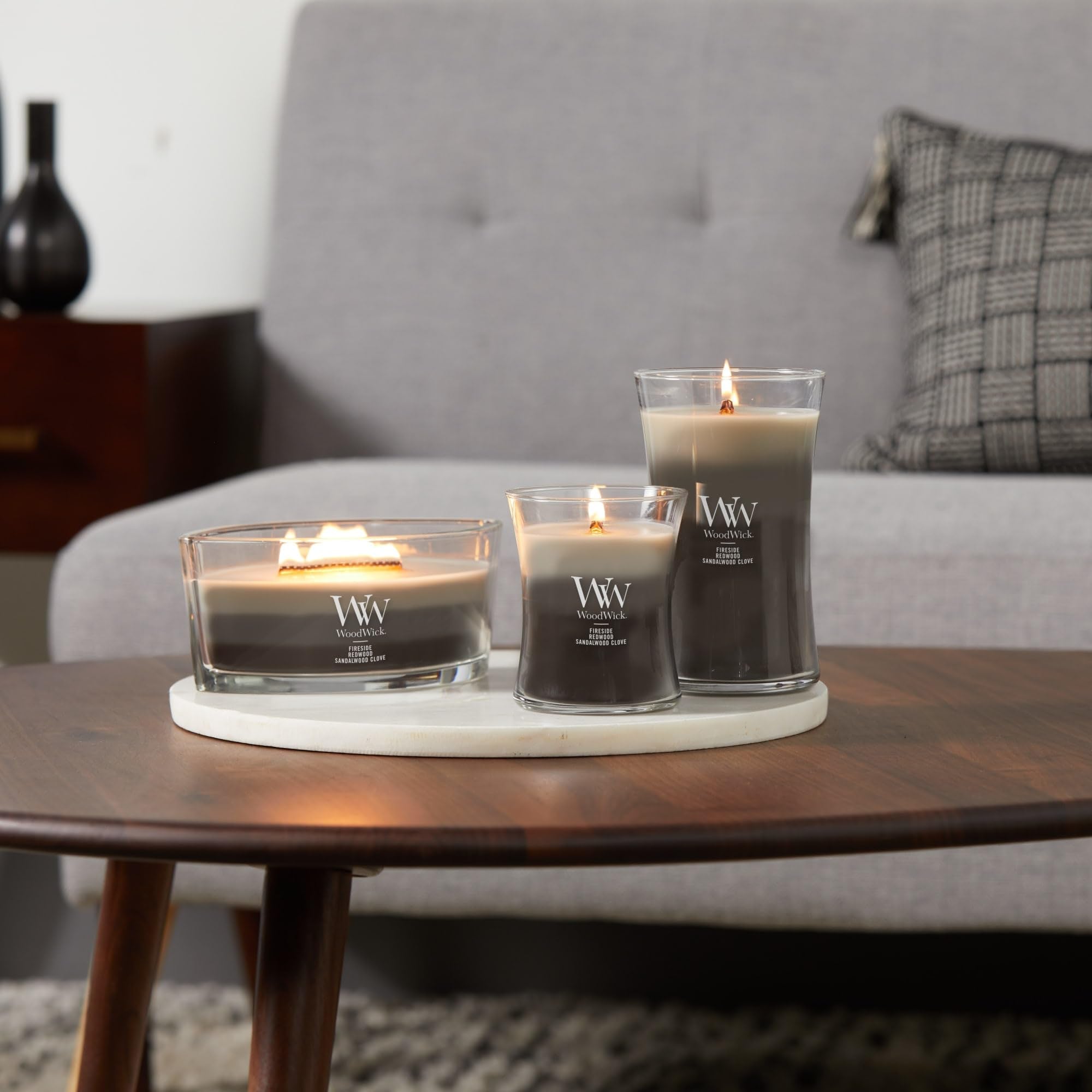 WoodWick Warm Woods Trilogy three-scent layering invites evolving fragrance during burn