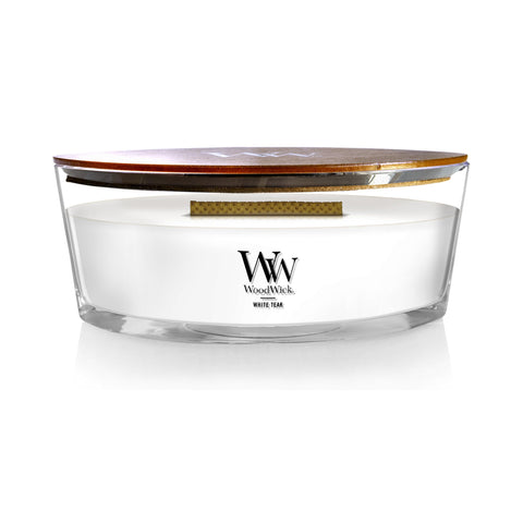 WoodWick White Teak ellipse candle with warm glow for cozy evenings.