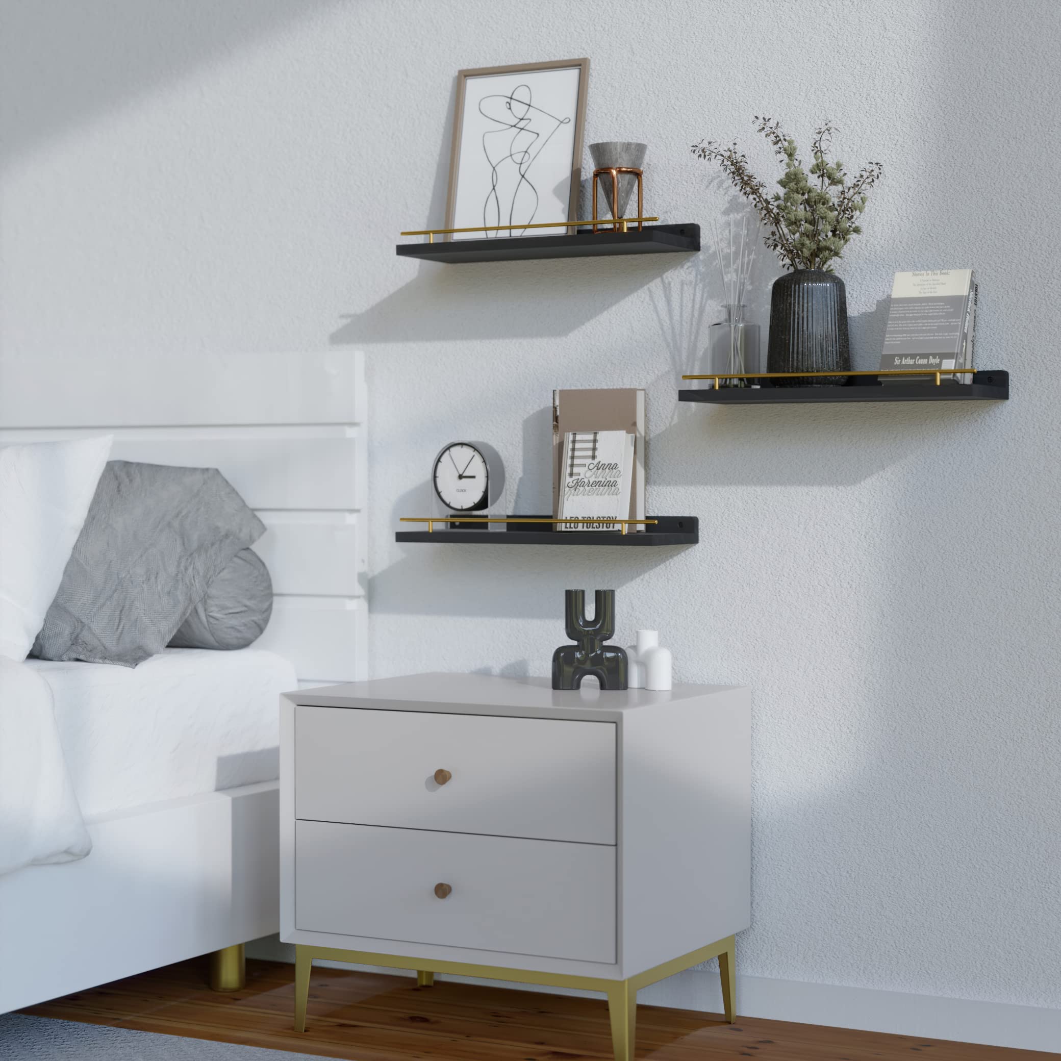 WOPITUES display of plants and books on black shelves with gold guardrail