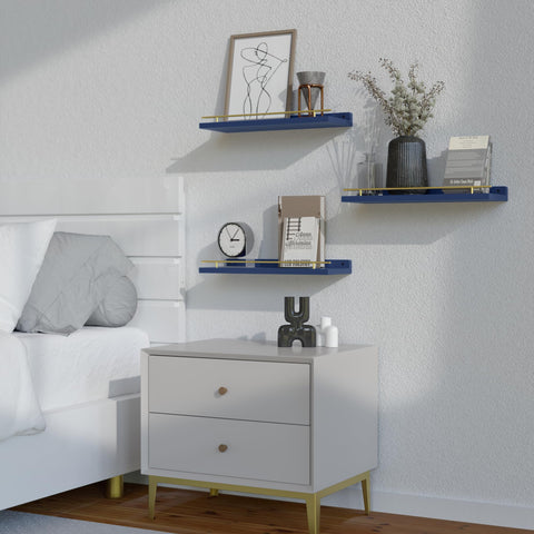 Small plants and books arranged on WOPITUES wall shelves