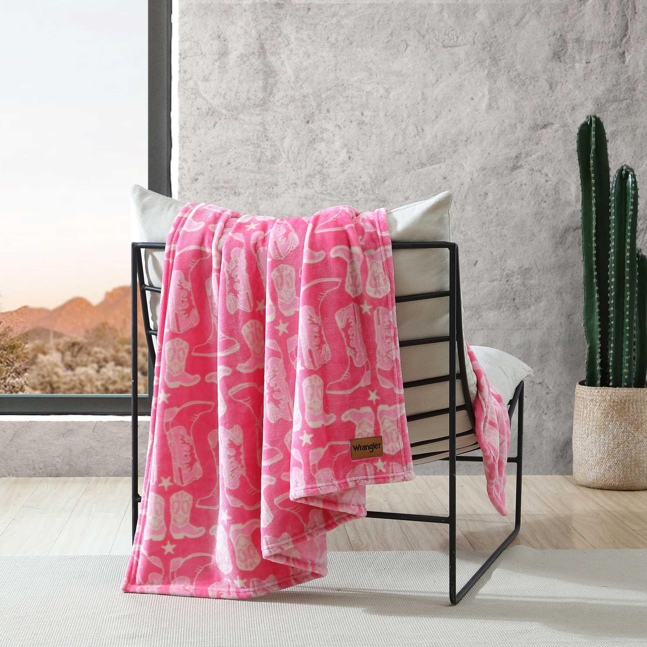 Wrangler plush blanket on a bed setup, inviting snug evenings.