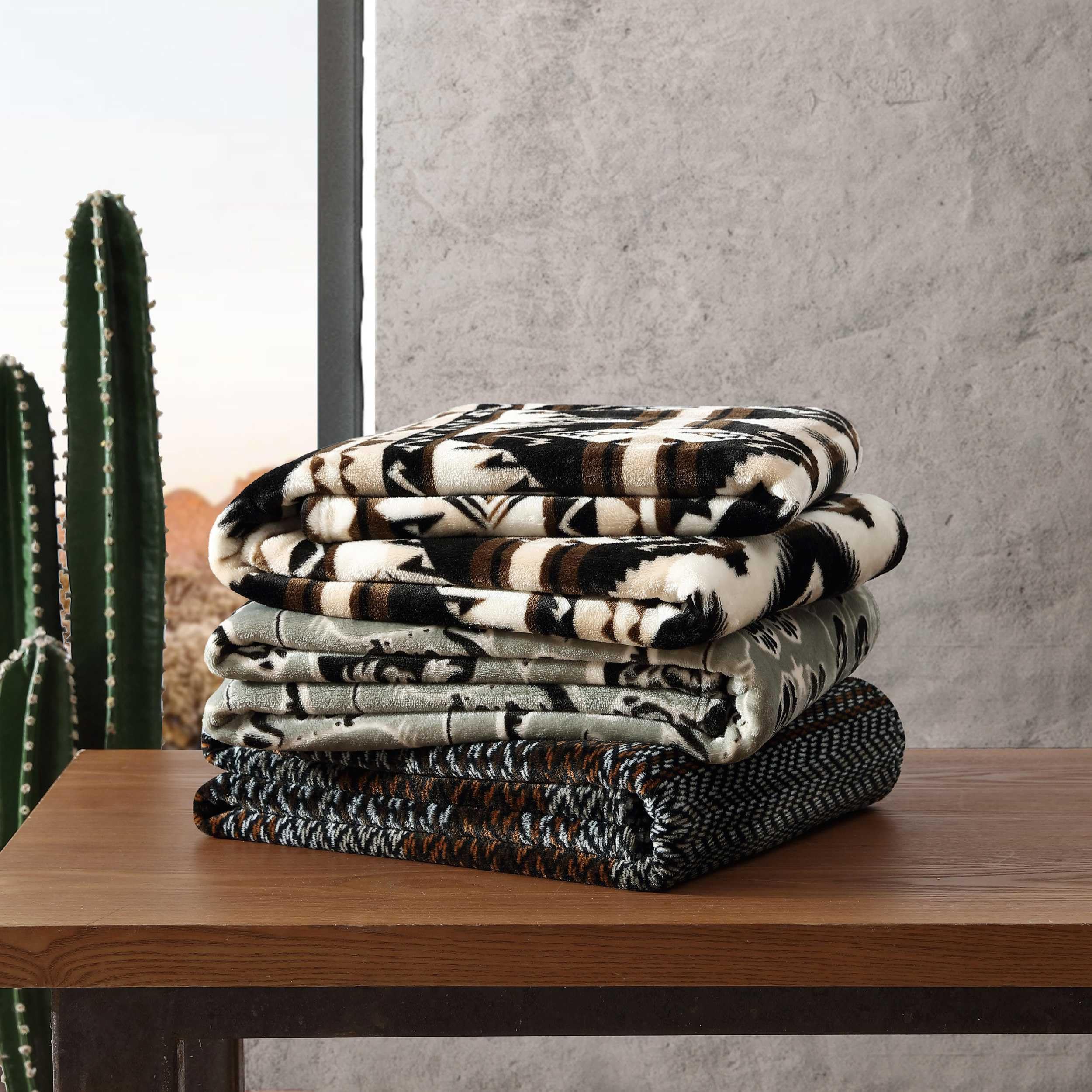 Wrangler Sherpa throw blanket staged in living room as lightweight warmth