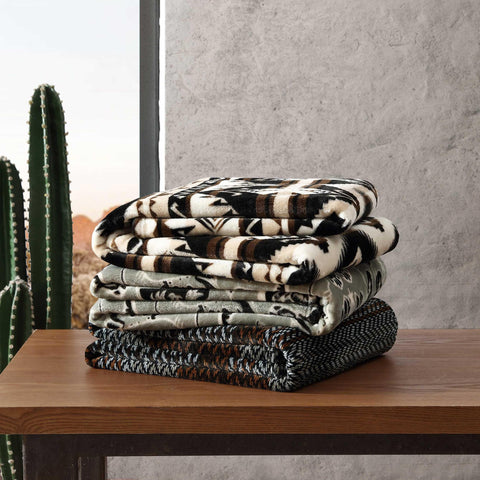 Wrangler Sherpa throw blanket staged in living room as lightweight warmth