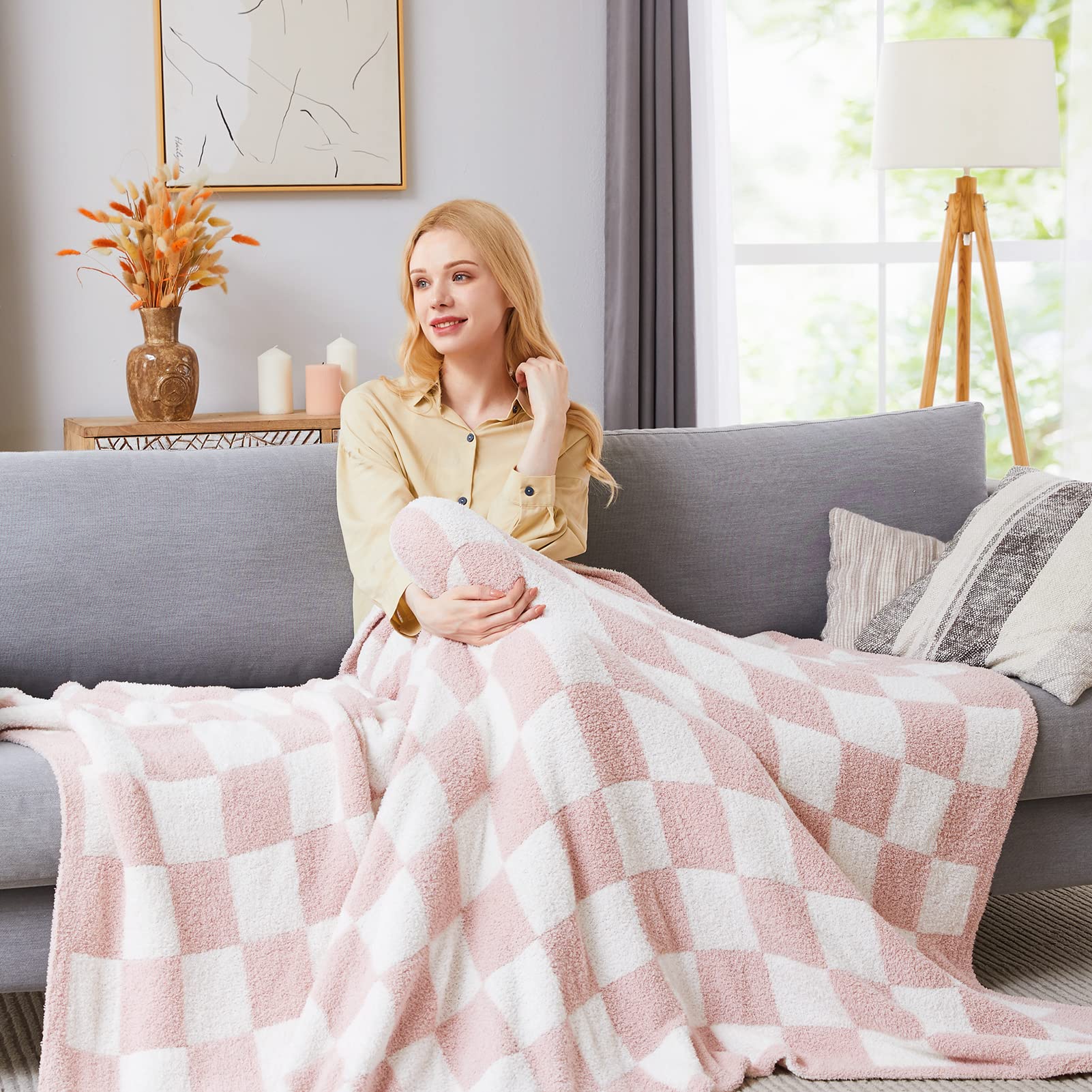 WRENSONGE checkered throw pink on couch demonstrates easy styling for cozy living spaces.