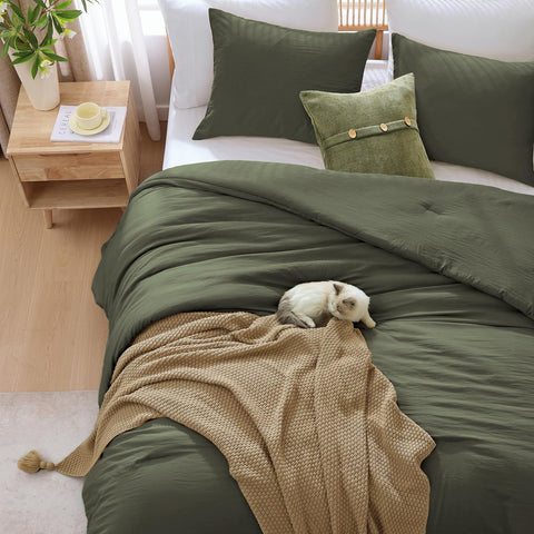 Wrensonge minimalist bedroom decor idea featuring olive-green bedding and clean lines.