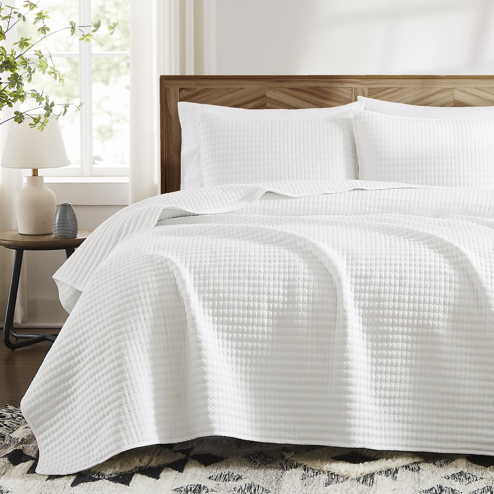 WRENSONGE white quilt set on a queen bed for all-season comfort.