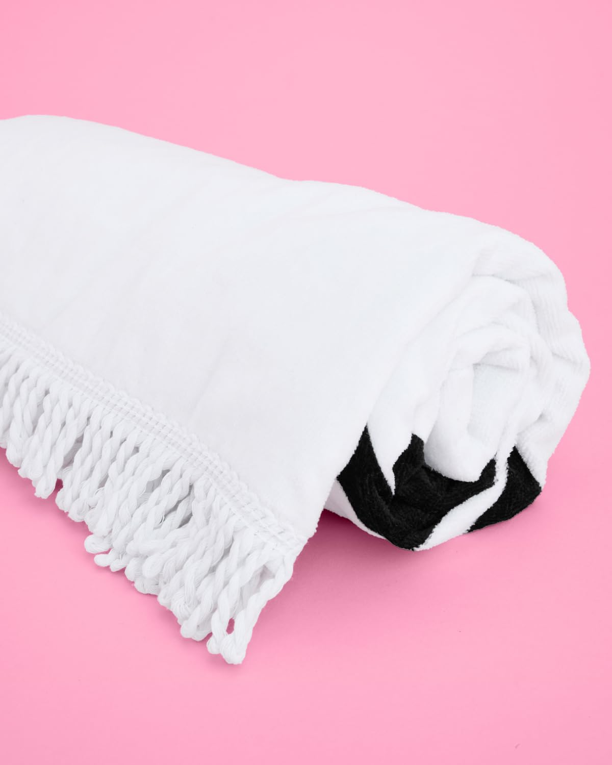 xo Fetti Bride Fringe Beach Towel on poolside chair during sunny day.