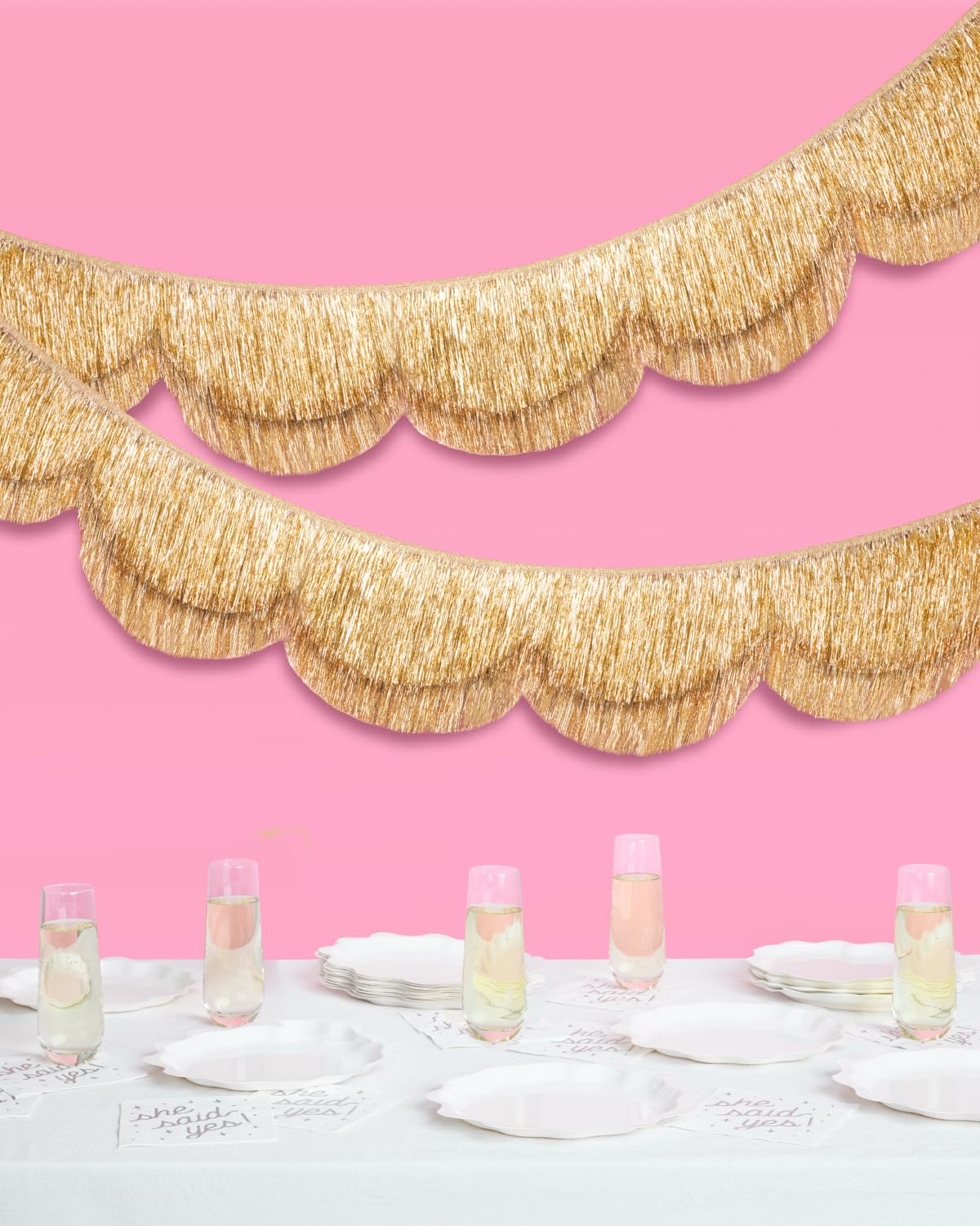 Close-up of gold foil fringe on the xo, Fetti banner captures shimmering mood