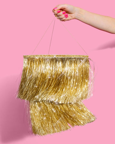 xo Fetti gold chandelier elevates NYE and party vibes with twinkling light